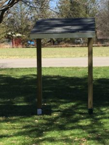 Sign Posts with roof attached.